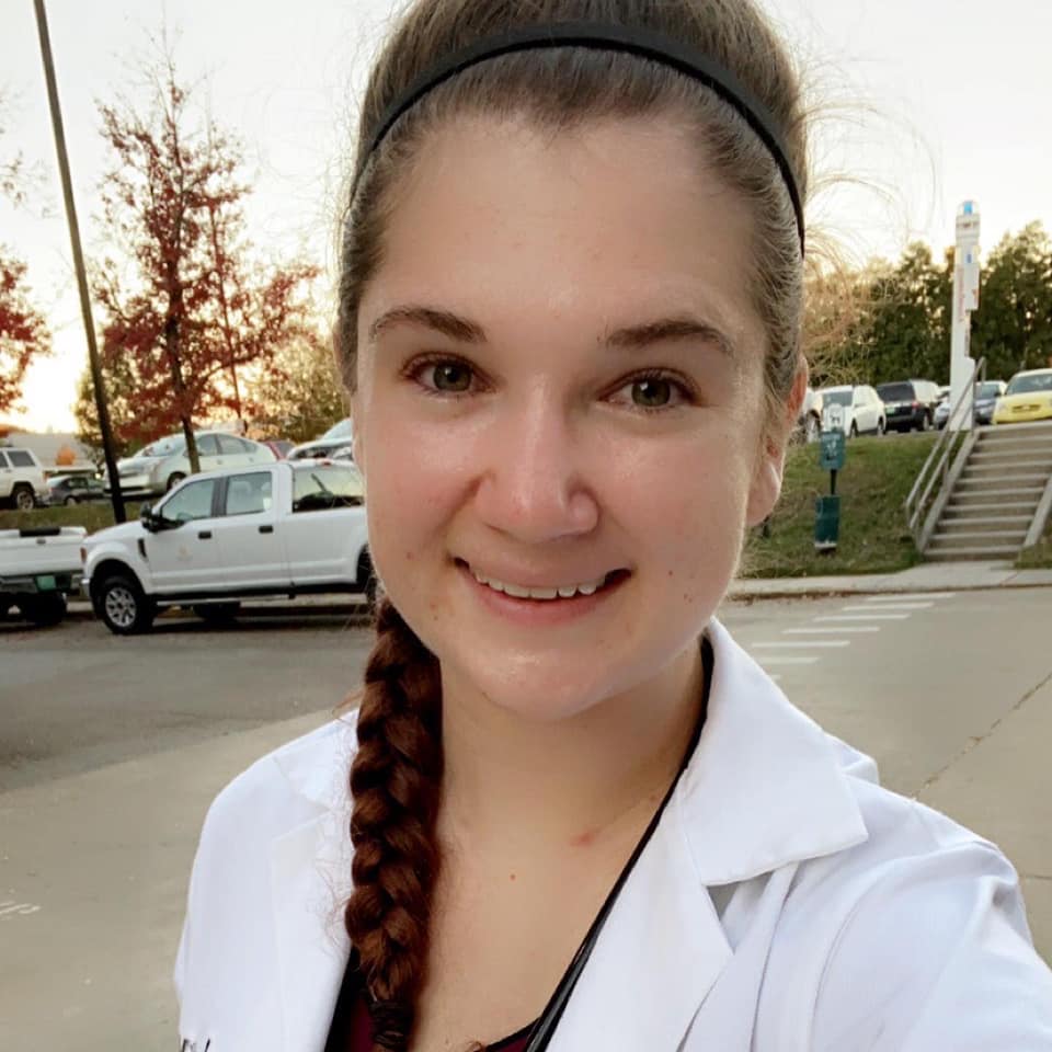 Veterinary student wearing a white coat