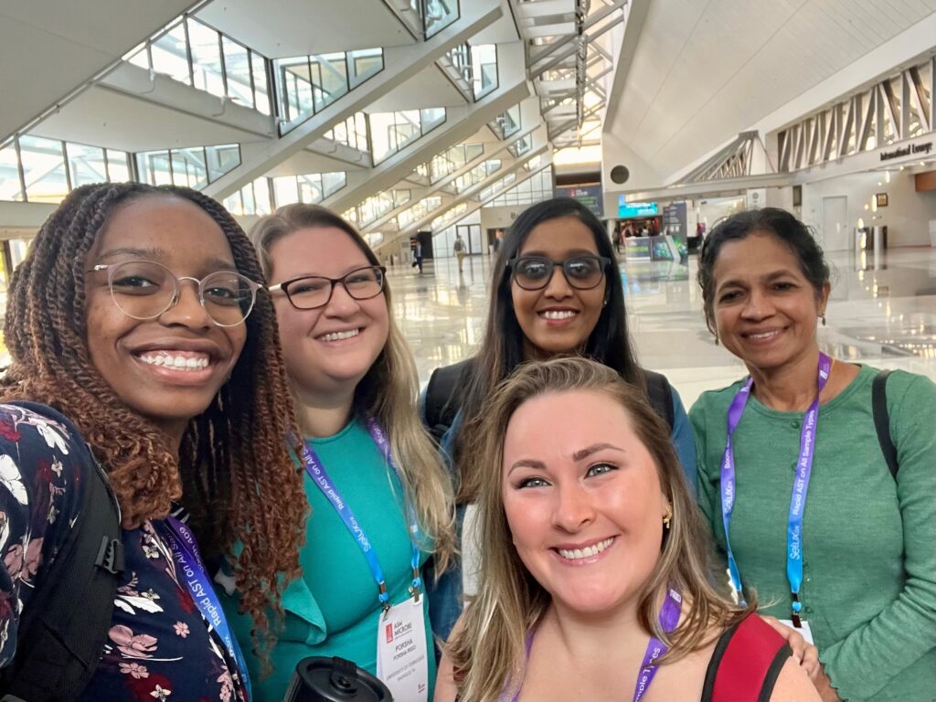 Microbiology lab members (from left to right) Bryanna Fayne, Porsha Reed, Swetha Madesh, Sreekumari Rajeev, and Liana Nunes-Barbosa (front) pose for a group photo at the conference.