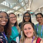 Microbiology lab members (from left to right) Bryanna Fayne, Porsha Reed, Swetha Madesh, Sreekumari Rajeev, and Liana Nunes-Barbosa (front) pose for a group photo at the conference.