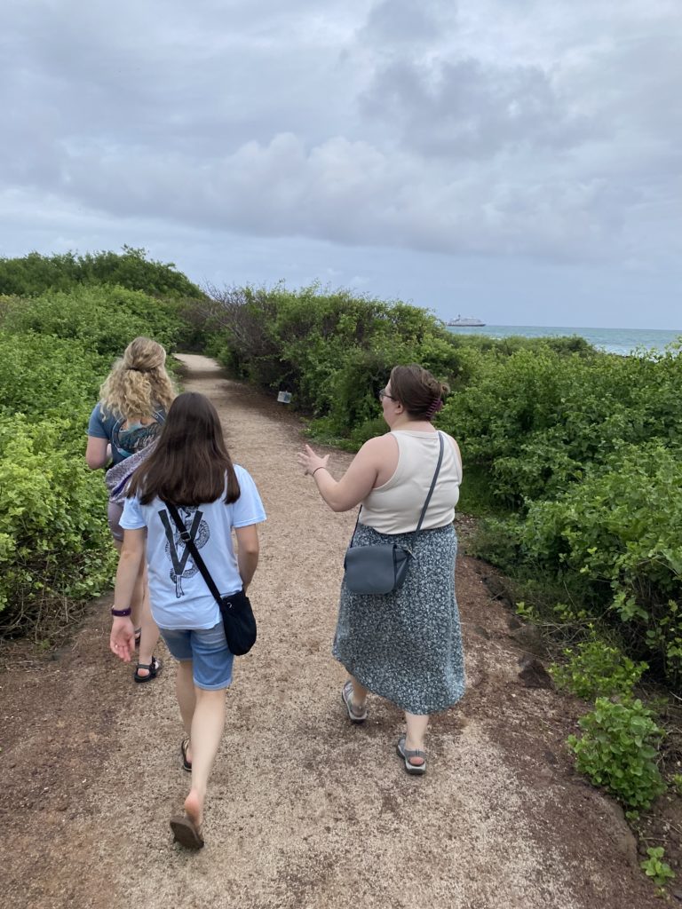 Vet Students walking on a sandy path in Galapagos