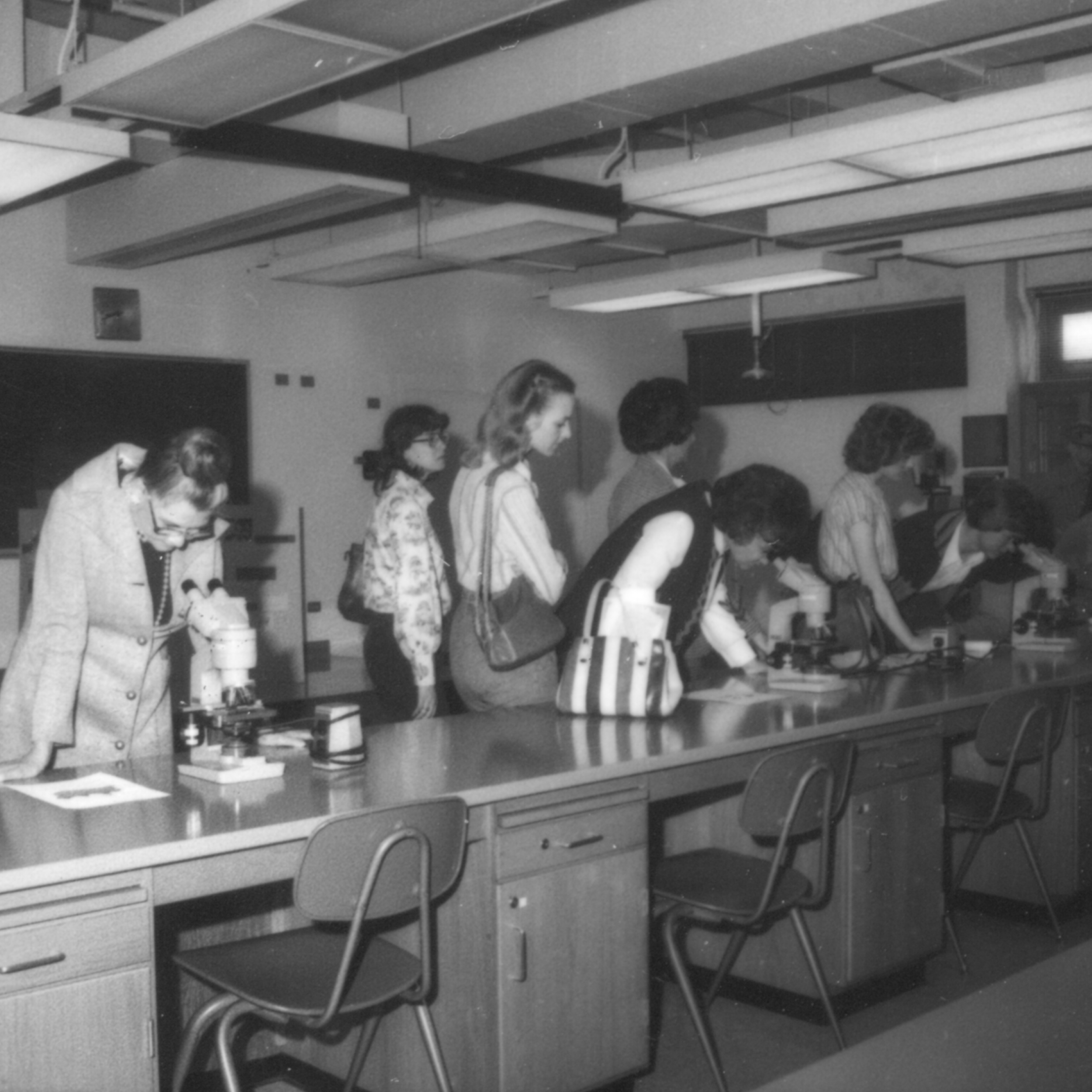 Attendees looking at microscopes at the first UTCVM open house in 1980 