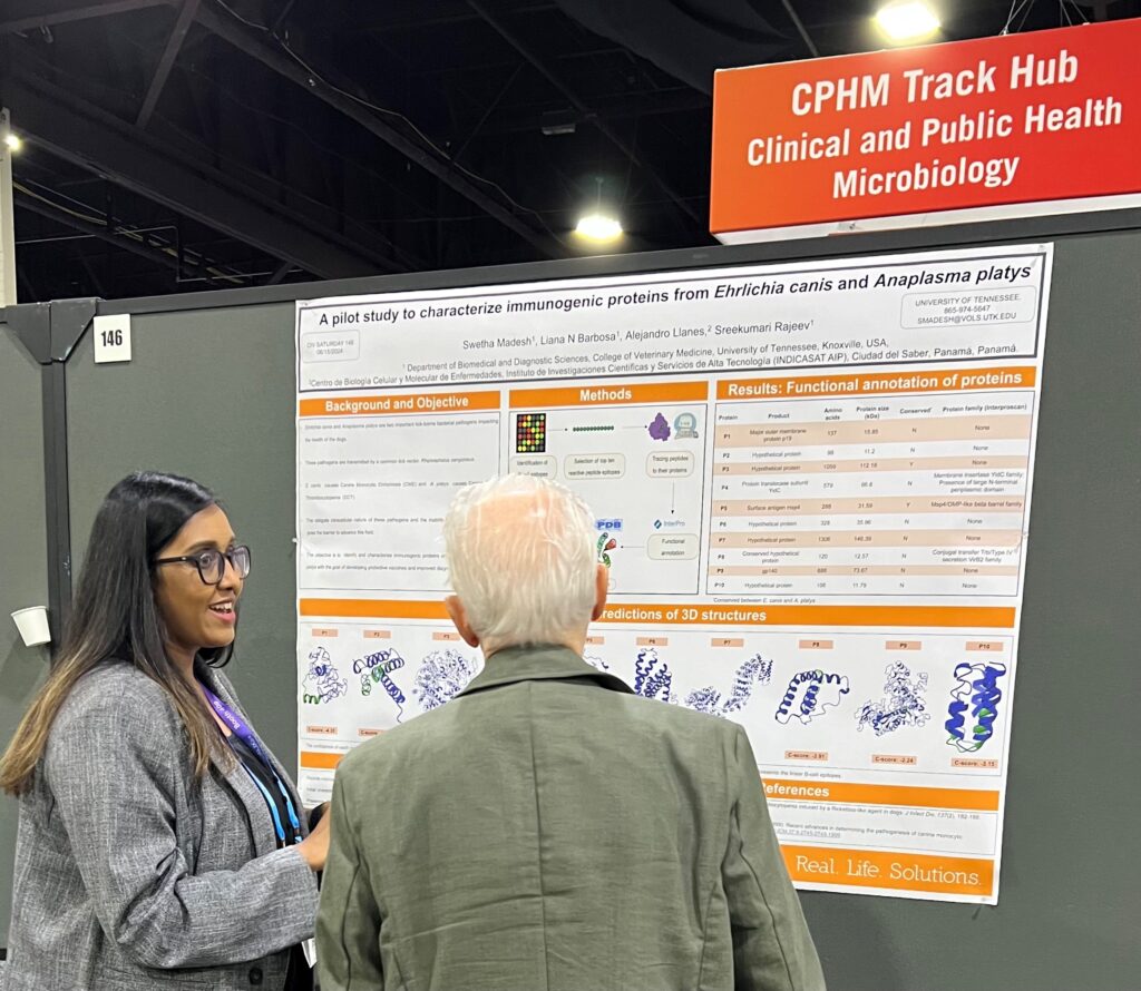 Swetha Madesh, a comparative and experimental medicine graduate student, shares her research, “A pilot study to Characterize Immunogenic proteins from Ehrlichia canis and Anaplasma platys,” with a conference attendee
