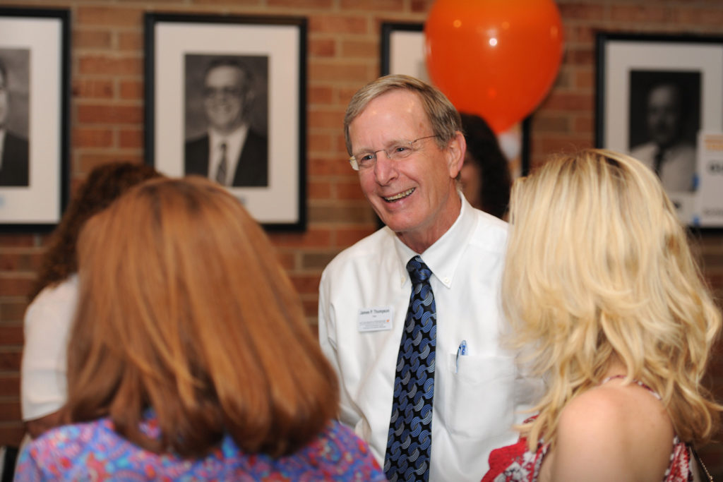 Dean Jim Thompson, wearing a blue tie and white shirt, talks to two people at the Tennessee Welcome